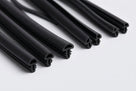 Several black rubber beading lengths fanned out on white background