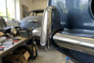 Chrome overrider with black rubber beading fitted to a dark blue classic Jaguar bumper