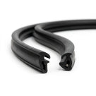 Black rubber outer waist seals, coiled pair showing keyhole profile, studio shot