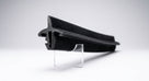 Black flocked rubber door seal profile on a stand, white background