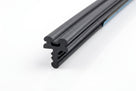 Twin-bulb rubber weatherseal profile with blue backing tape, studio close-up