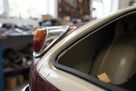 Self-adhesive foam strip fitted along a two-tone classic car's rear window edge