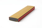 Foam strip shown with tan paper facing and a red edge strip, black foam core visible