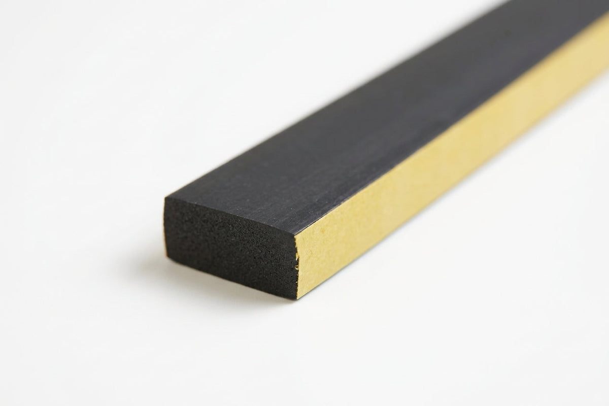 Black closed-cell foam strip shown with its gold adhesive backing paper peeled back