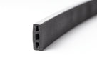 Black closed-cell foam strip curved, showing its triple-chamber hollow profile