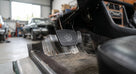 Rubber brake pedal fitted in a Triumph Stag footwell, low angle workshop view