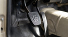 Black rubber pedal pad fitted to a pedal arm in a classic car footwell