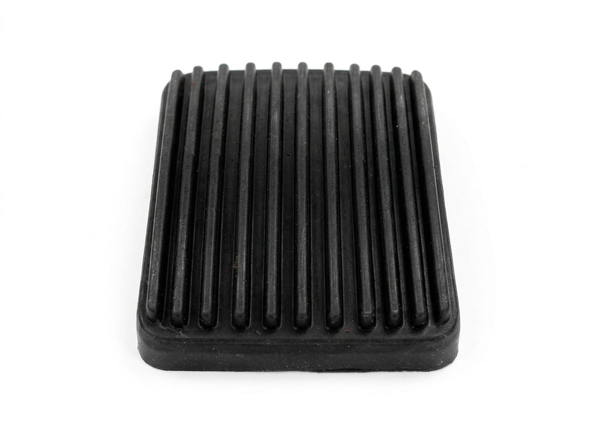 Black ribbed rubber accelerator pedal pad, angled studio shot on white background