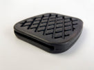 Black rubber pedal pad with a diamond cross-hatch tread, studio shot