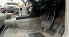 Ribbed black pedal pad fitted in a carpeted classic car footwell