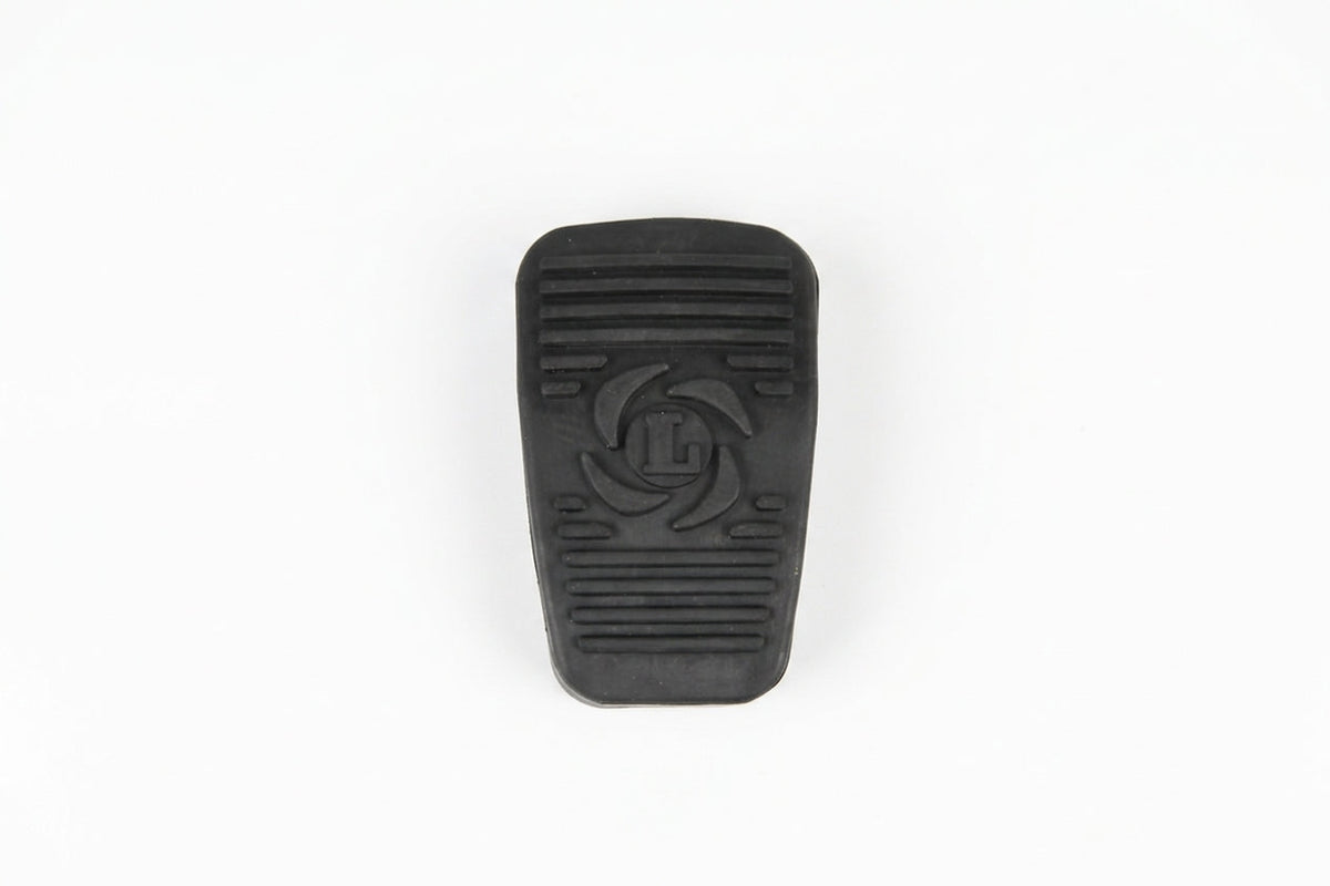 Black ribbed accelerator pedal pad with embossed logo, studio white background