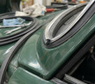Chrome PVC insert fitted along a green classic car's windscreen surround
