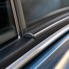 Chrome insert fitted along a car door window channel, close-up in situ