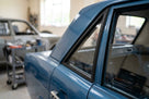Black quarterlight seal fitted to a blue Cortina Mk2's rear side window, workshop