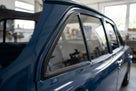 Black quarterlight seal fitted to a dark blue Escort Mk1's rear side window
