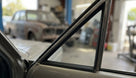Fixed quarterlight seal fitted to a cream Cortina 1600E's side window, workshop