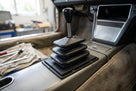 Gaiter fitted around the gear lever on the centre console of a classic car