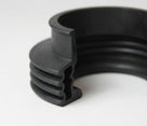 Black ribbed rubber gaiter with a bellows profile, close-up studio shot