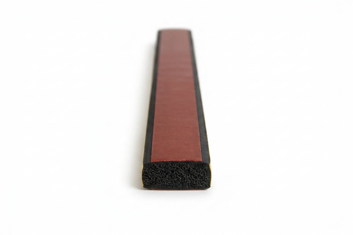 Flat black sponge strip with maroon release liner along the back, studio shot showing cut end