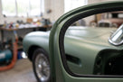 Black sponge seal fitted around a door aperture of a green classic sports car