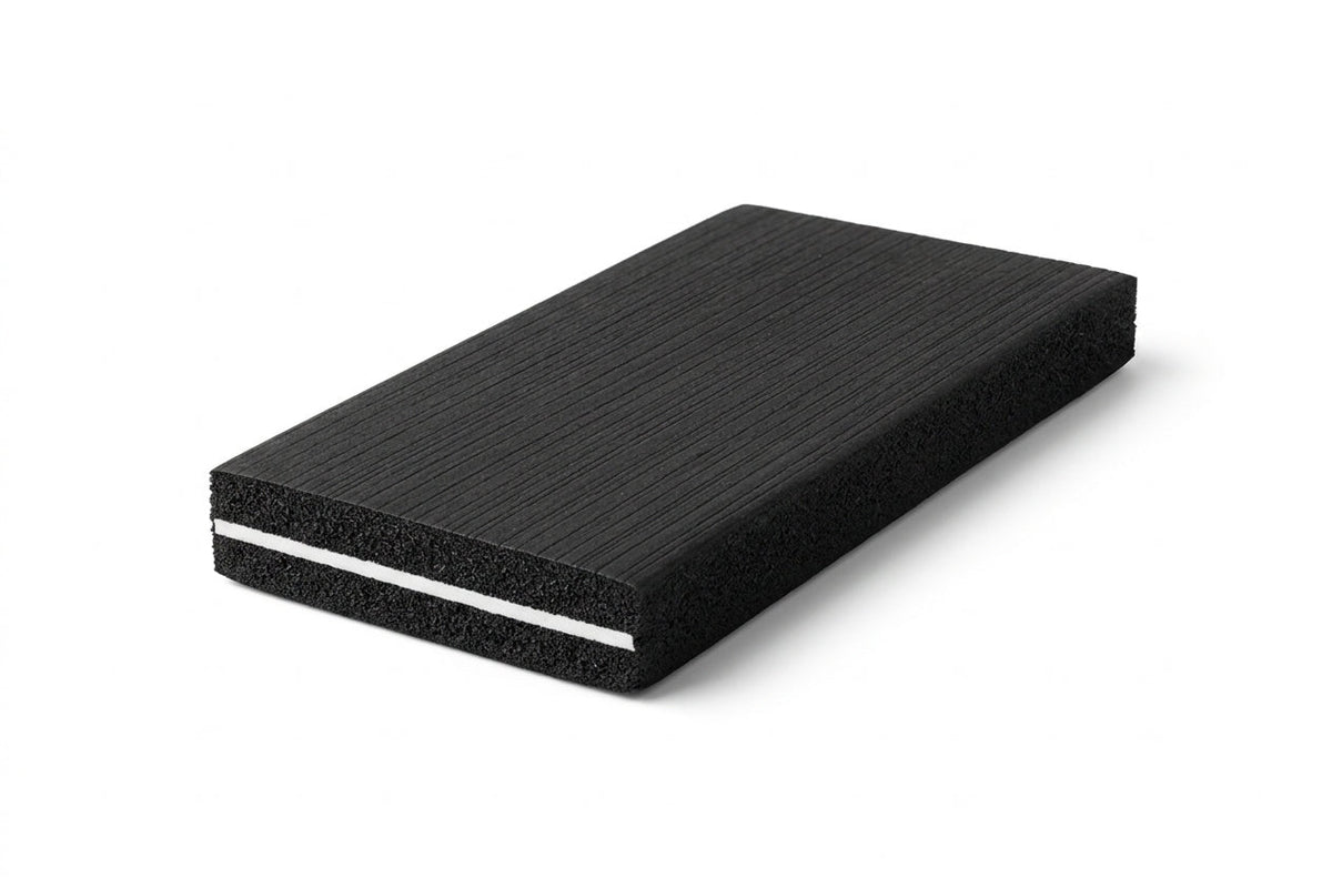 Thick black sponge slab with a thin white core line running through the middle, studio shot