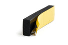 Black sponge strip block with yellow adhesive backing partly peeled away, studio shot