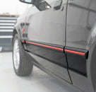 Black door moulding with red insert fitted along a black Escort XR3i's door