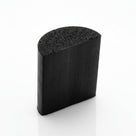 Black half-round sponge rubber section, cut end showing the porous domed face