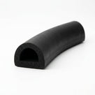 Curved length of black D-section sponge rubber showing the hollow bore at the cut end