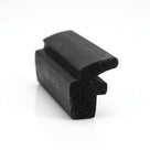 Black expanded neoprene section with a hooked flange, cut end showing porous cell structure