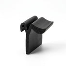 Black expanded neoprene sponge profile end cut, showing open-cell porous texture, studio shot