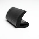 Black sponge rubber hollow seal section, angled end-on view on white background