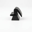 Black dual-hardness sponge section seal, end-on studio shot showing the profile