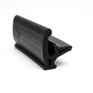 Black sponge rubber seal with curved cap and hollow leg, angled studio shot