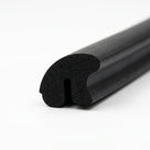 Black sponge rubber seal with curled notch, angled length shot on white background