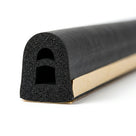 Black arched sponge section with square-topped hollow bore and gold adhesive backing, cut end