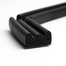Black triple-bead sponge crown strip curved into a U-shape, adhesive backing visible on the cut end