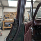 Double bubble seal fitted to a classic car door aperture in a workshop