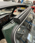 Windscreen seal fitted to the top rail of a green classic car's windscreen