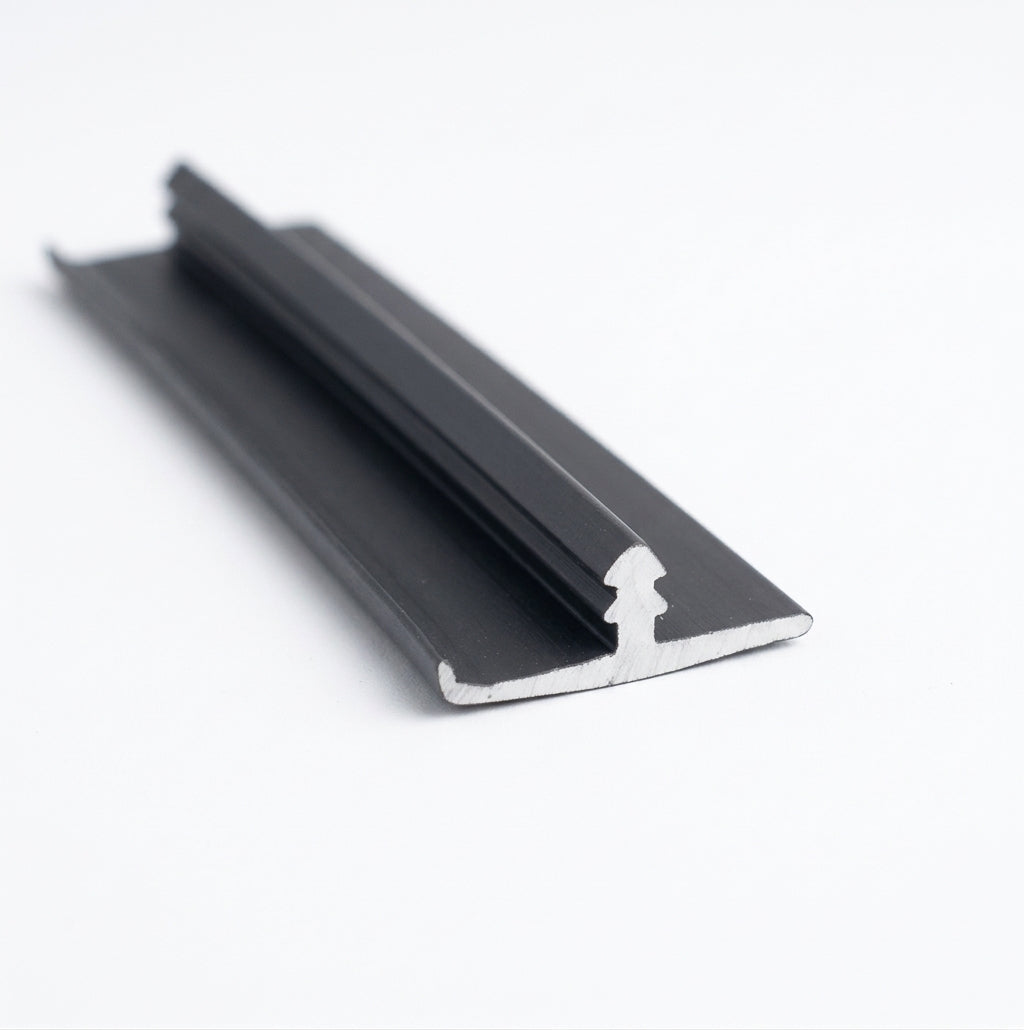 Black edge trim fitted around a window frame on a dark red classic car