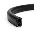 Coiled length of black PVC self-grip edging strip with visible grip channel