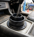 Black rubber gaiter fitted around the gear lever on a car centre console