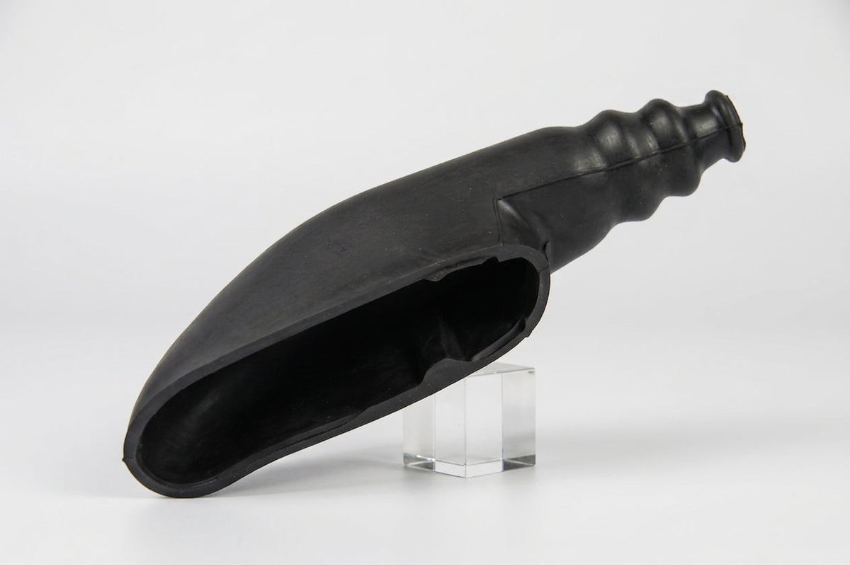Black elongated rubber handbrake gaiter, side view on studio stand