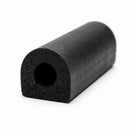 Black D-section sponge rubber extrusion with round hollow bore, cut end on white background