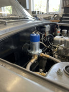 Blue-top electronic fuel pump fitted in the engine bay of a classic MG