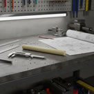 Cream natural cast nylon 6 rod on a workshop bench with callipers and a technical drawing