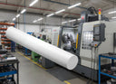 White UHMWPE rod composited across a CNC turning centre on a factory floor