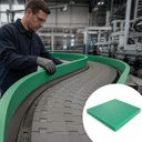 Worker fitting green curved guide rails along a chain conveyor bend, inset green sheet