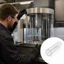 Machinist beside a CNC machine with a large clear acrylic tube guard around the spindle; inset shows a plain tube.