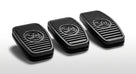 Three black ribbed rubber pedal pads with embossed logo, studio shot